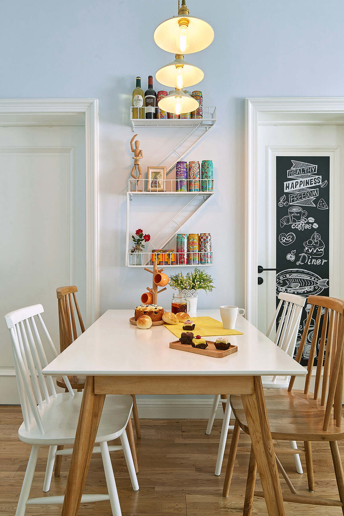 餐桌和餐椅采用白色和实木混搭，色彩上的碰撞让餐厅更加丰富。简单的吊灯，暖黄色的灯光让餐厅更加温馨。